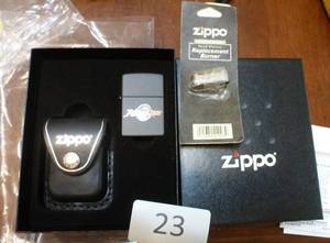 lot 23 image: New Zippo lighter and New replacement burner