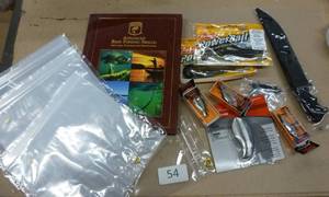 lot 54 image: Fishing lot - filet knife, bait, rapala lures, worm bags, map bag, berkeley stainless soap