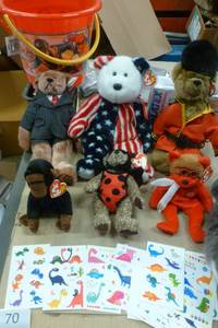 lot 70 image: Sand pail full of beanie babies and dinosaur temporary tatoos