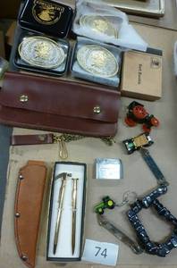 lot 74 image: 5 belt buckles, truckers wallet with chain, knife sheath, lighter, grain belt opener