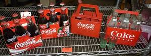 lot 201 image: Coca-Cola Bottles and Plastic Carrying Cases - two six packs are full - all are 8 oz size
