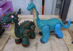 lot 212 image: Two dinosaurs - dark green is battery operated