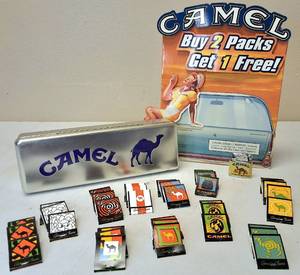 lot 23 image: CAMEL Promotional from the 1990s era Classic counter sign, 38 matches with 11 designs, CAMEL Lighter  and collectors tin