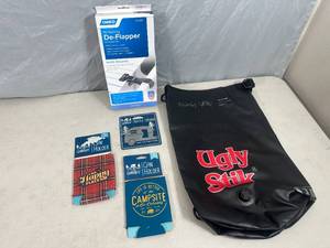 lot 57 image: Ugly Stik Dry Bag, New RV Awning De-Flapper Set, Can Coolers, Bottle Opener