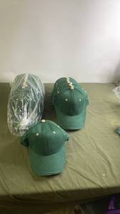 lot 131 image: Collection of 24 Green Baseball Caps with White Buttons