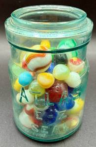 lot 45 image: Collection of Vintage Marbles in Atlas Blue Jar- Inlcudes a few Shooters and Uranium Glass marbles