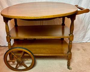 lot 65 image: Vintage Solid Maple Drop Leaf Tea Cart with one drawer on 2 wooden spoke wheels with rubber tires and 2 castors