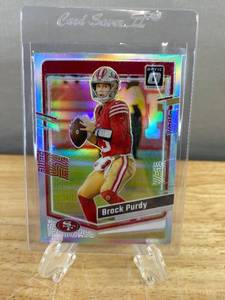 lot 236 image: 2023 Brock Purdy NFL Panini Optic Silver Prizm Trading Card No. 168 J
