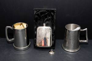 lot 506 image: Set of Three Pewter Collectibles  Steins & Flask