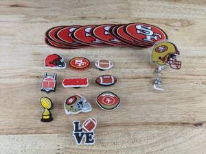 lot 332 image: Brand New San Francisco 49ers NFL Croc Charms, Patches, and Retractable Badge Holder Set