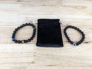 lot 833 image: Brand New Set of 2 Stretchable Lucky Evil Eye Black Tourmaline Healing Crystal Bracelets