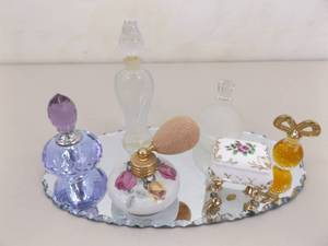 lot 82 image: Lot of Vintage Perfume Bottles on a Small Dresser Mirror