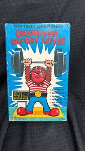 lot 30 image: Vintage Battery-Operated Champion Weight Lifter Toy