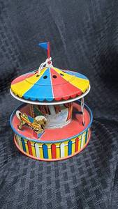 lot 45 image: Vintage Wind-Up Carousel Tin Toy with Colorful Design