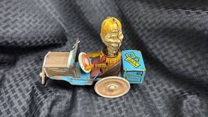 lot 47 image: Vintage Mortimer Snerd Wind-Up Tin Toy Car