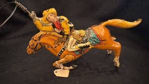 lot 146 image: Vintage Tin Cowboy Rodeo Toy with Horse and Lasso