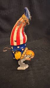 lot 153 image: Vintage Acrobat Clown Wind-Up Toy with Patriotic Colors