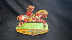lot 194 image: Vintage Red Ranger Ride Em Cowboy Wind-Up Toy