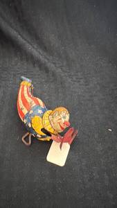 lot 197 image: Vintage Mechanical Tin Clown Toy with Patriotic Design