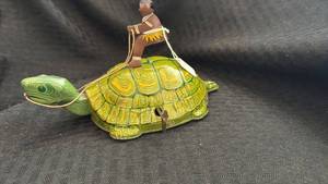 lot 203 image: Vintage Wind-Up Tin Turtle Toy with Rider