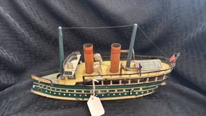lot 207 image: Antique Tin Wind-Up Ocean Liner Toy with Visible Wear