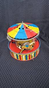 lot 315 image: Vintage Tin Wind-Up Carousel Toy with Surface Wear