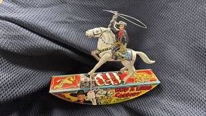 lot 356 image: Vintage Hoppy L. Cassidy Metal Wind-Up Toy with Surface Scratches and Rust