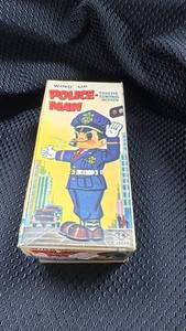 lot 360 image: Vintage Wind-Up Police Man Toy with Original Box