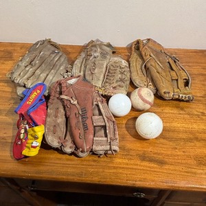 lot 110 image: Lot Gloves - BaseballSoftball gloves, one baseball, two plastic baseballs, 1 Padded Toddler Glove