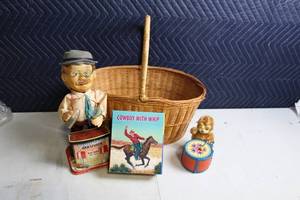 lot 312 image: Collection of Vintage Toys Cowboy Book, Charley Weaver Bartender Toy, Drumming Bear, and Woven Basket