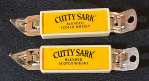 lot 298 image: Two Vintage Cutty Sark Blended Scotch Whisky Bottle  Can Openers