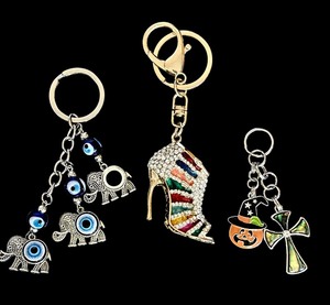 lot 128 image: Fun Whimsical Key Chains Including Blue Evil Eye Keychain, Elephant Blue Eye Good Luck Blessing Charm and More
