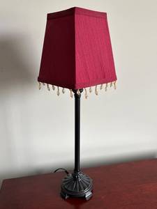 lot 29 image: Elegant Table Lamp with Red Shade and Decorative Fringe