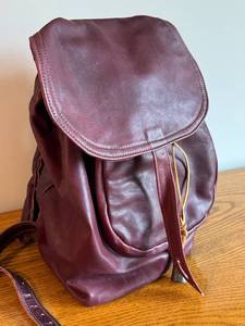 lot 87 image: Bare Skin Leather Drawstring Backpack in Burgundy
