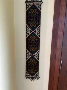 lot 90 image: Handcrafted Wool Wall Hanging with Ornate Geometric Patterns