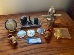 lot 153 image: Assorted Collection of Souvenirs including Paris Sculptures, Decorative Windmill, Miniature Clock, Wooden Clogs, and Commemorative Coins
