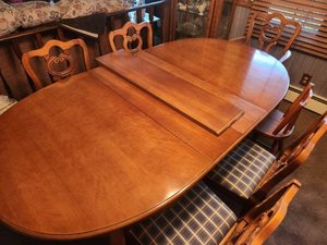 lot 28 image: Dining Room Table with 6 Chairs, a small child chair, and a total of 3 Leaf Extensions and Protective Pads for Table and Leaves