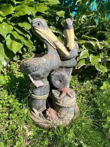 lot 97 image: Garden Sculpture Featuring Two Pelicans on Wooden Posts