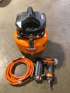 RIDGID 6 Gal. 150 PSI Portable Electric Oil-Free Jobsite Pancake Air Compressor with 25 ft. Air Hose and 18GA Brad Nailer     Customer Returns See Pictures