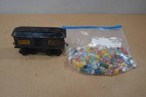 lot 130 image: Bag of Marbles with Toy Train