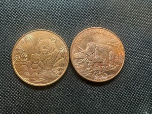 lot 99 image: Two Copper One Ounce Rounds Triceratops and Bears Designs