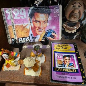 lot 12 image: MCM Elvis Presley USA Commemorative Postage Stamp Jigsaw Puzzle,  Magnets by Mail Elvis Presley, Retirement Fund hobo Bank,  sake bottle and More