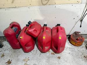 lot 54 image: Set of Red Fuel Containers with Varying Sizes
