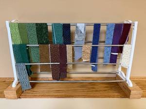 lot 376 image: Collection of Assorted Fabric Strips on Rack