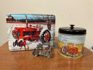 lot 36 image: 2 Farmall tins and tractor cookie cutter
