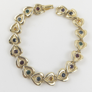 lot 61 image: Multi-Colored Rhinestone Accented Gold Tone Base Metal Heart Link Bracelet.