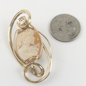 lot 70 image: Carved Shell Cameo Gold Filled Wire Wrapped Pendent (No Chain) . New Old Stock Estimated Replacement value $175