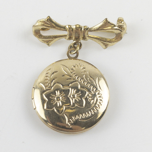 lot 91 image: Cute Bow & Locket Gold Tone Base Metal Brooch .