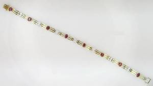 lot 3A image: Ladys 18k yellow gold and ruby bracelet with diamond accents.