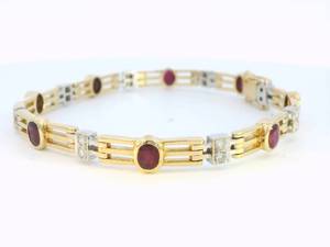 Lady's 18k yellow gold and ruby bracelet with diamond accents.
